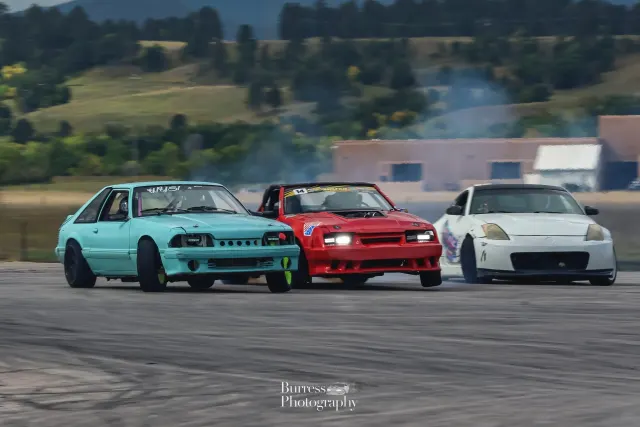 Three-car train: teal Fox body, red Fox body and white 350Z